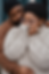 Cuddling plus sized black Couple dressed warm enjoying each other