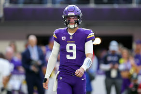 JJ McCarthy on the Minnesota Vikings walks onto the field at US Bank Stadium against the Chicago Bears.