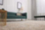 Stylish living room with soft beige carpet, coffee table and sofa, low angle view. Interio