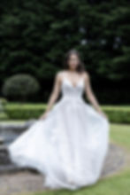 wedding gown in tulle and lace, spaghetti straps and deep v neck. A-line skirt, nice bodice, expensive look but affordable price