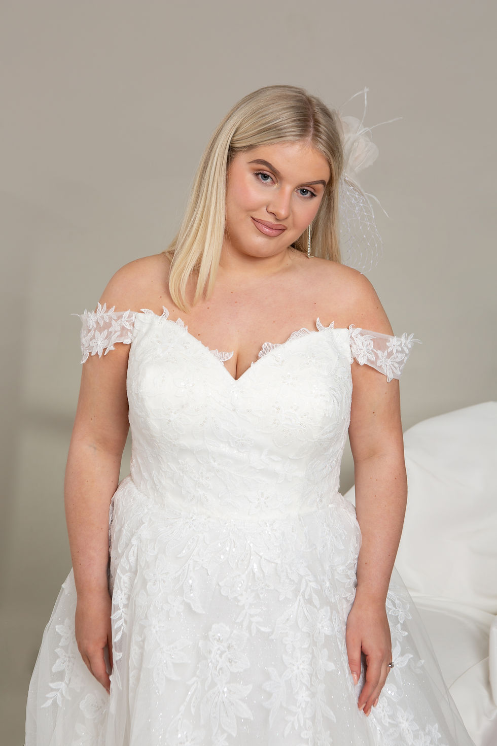 Off shoulder wedding dress with lace bodice and full skirt. Lace details on the skirt and bodice