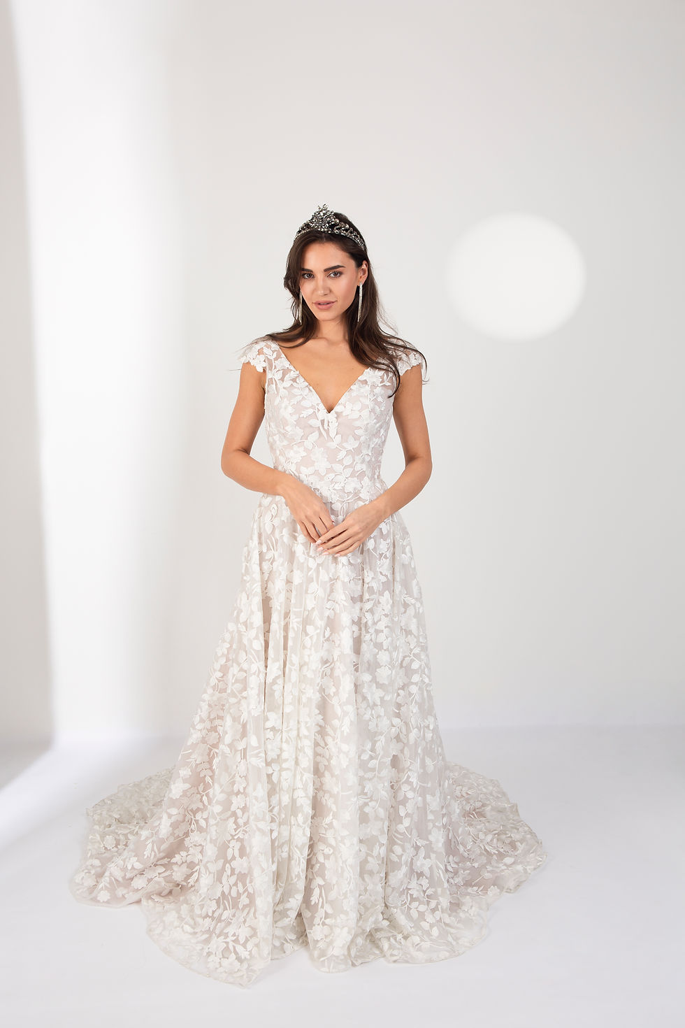 Lace and tulle ivory and nude bridal dress with of-shoulder straps and lace applique all over the bodice for beach wedding