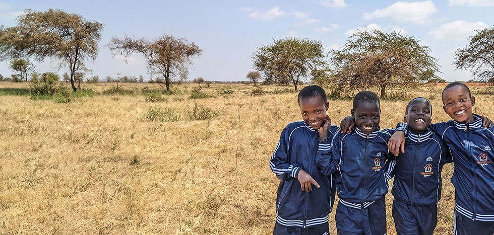 Smiling Maasai children in Promise Village Academy uniforms