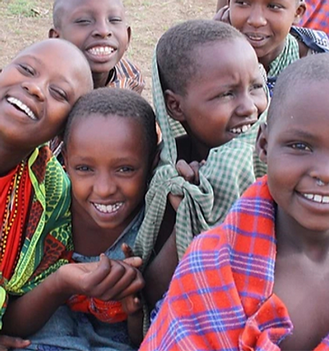 Smiling Maasai children wrapped in traditional shuka