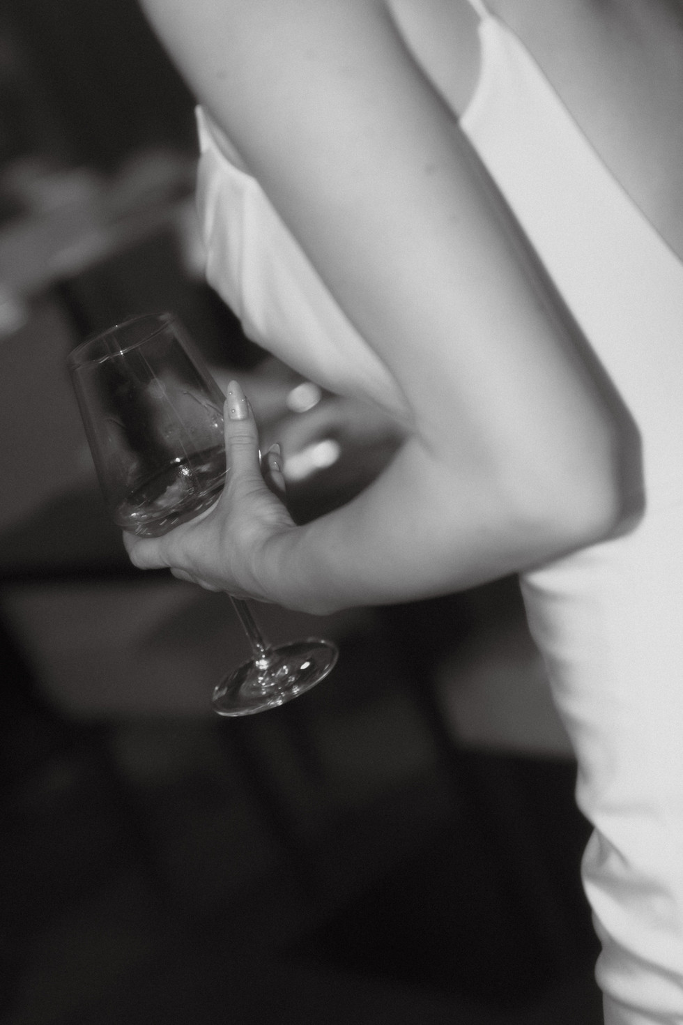 a candid shot of the bride holding her white wine