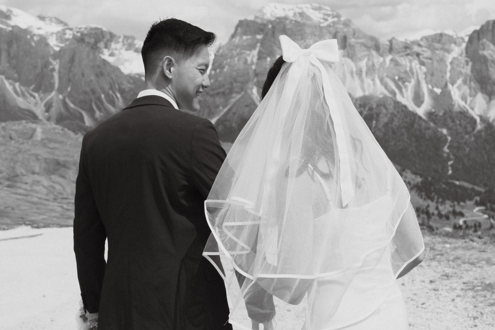 black and white photo of the groom looking at the bride from a behind shot in a prewedding shoot at seceda