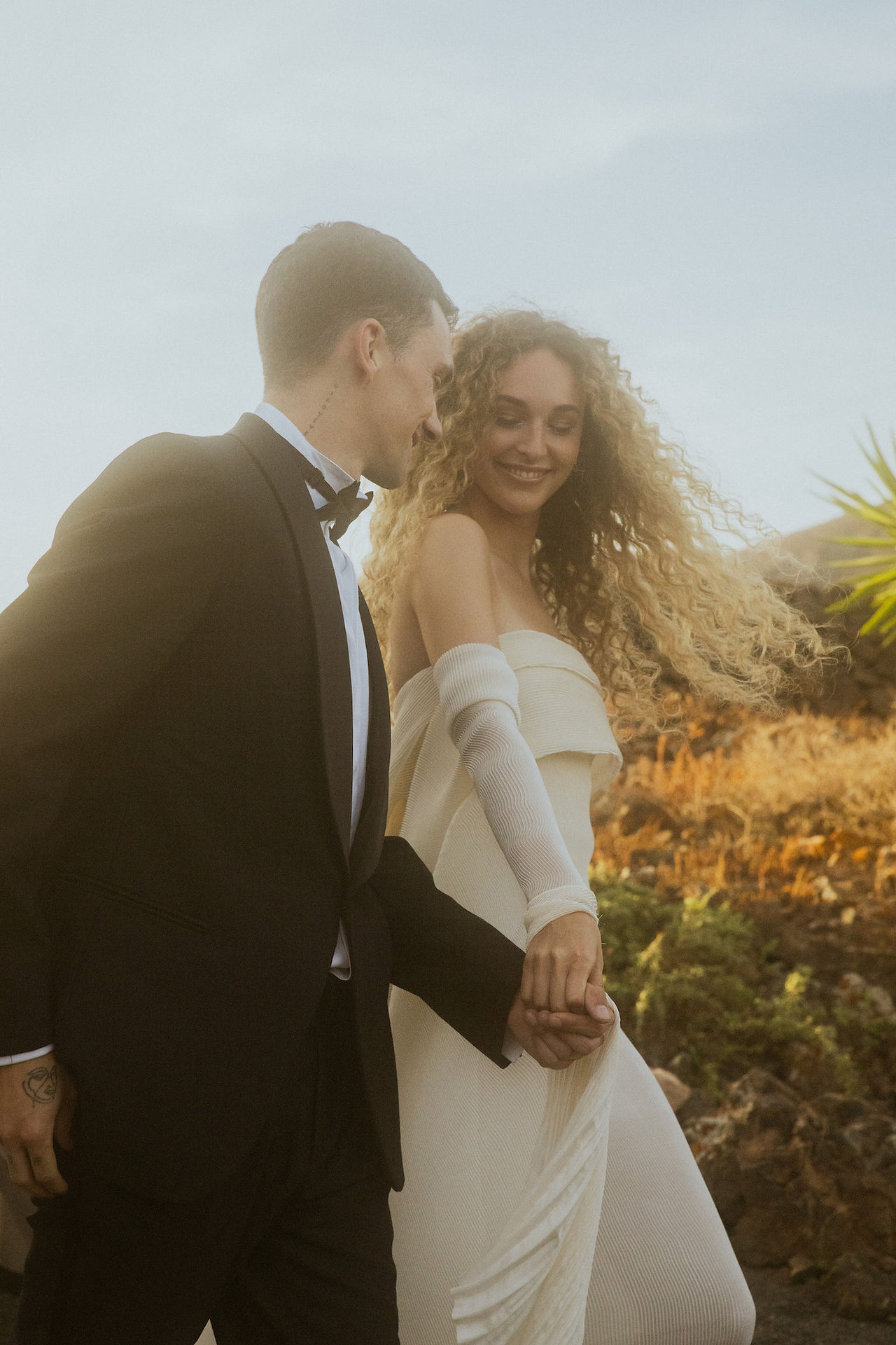 bride and groom joyfully walk hand in hand exiting the ceremony laughing