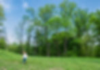 Girl running through tregaron meadow