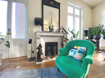 salon avec canapé velour vert pomme cheminée grand miroir