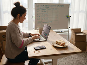 Ecommerce owner at desk managing social media tasks