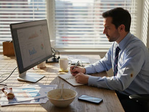 Ecommerce manager reviews analytics at cluttered desk