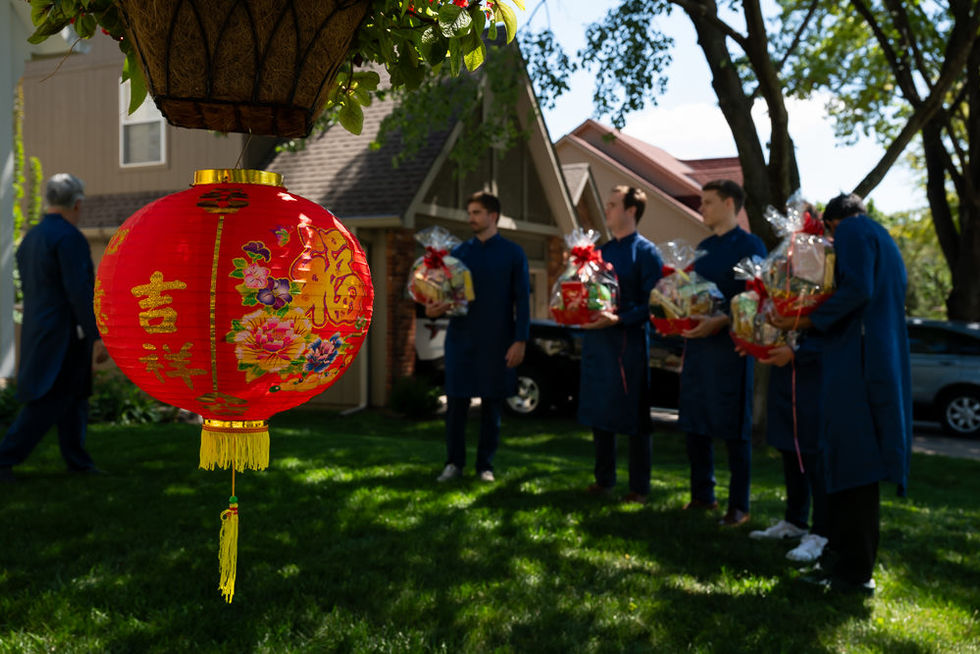Red Vietnamese decorative bowl with groomsmen lining up with gifts in the front yard