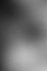 Black and white photo: A tender moment as the bride's mother gently adjusts Tamieka's hair before the wedding.