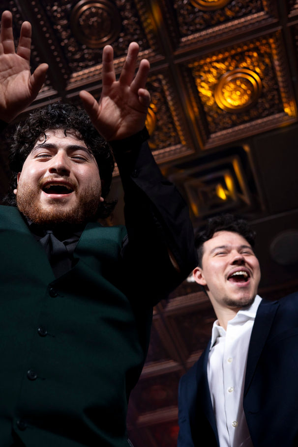 Two groomsmen are dancing and showing very expressive faces of joy during the party at The Pavilion Event Space in Kansas City.