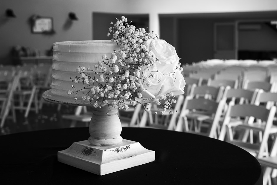 28 event space wedding venue with white chairs and wedding cake