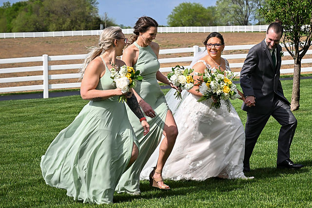 bridal party walking down a field during a wedding at Lone Summit Ranch.