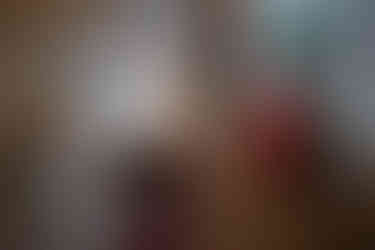 Bride looking down at her bridesmaid from the second floor