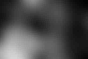 Black and white photo: Bride Tamieka and groom Drake share a fun and playful moment as they play Super Mario Kart at a bar near The Stanley.