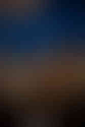 silhouette of 2 vendors discussing under the night sky in the patio of Unity Village