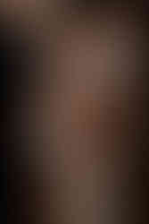 Close-up of six hands adjusting the bride’s wedding dress before the ceremony.