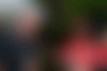 Two wedding vendors sharing a full, joyful laugh together