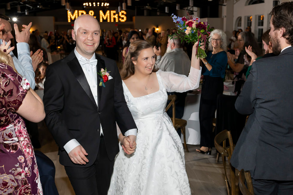 Joyful grand entrance of the bride and groom during the reception