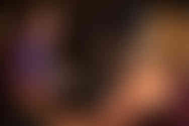 Couple dancing, with the man smiling broadly; his face also reflects in the mirror.