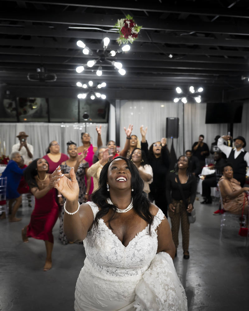 bride throwing bouquet at reception