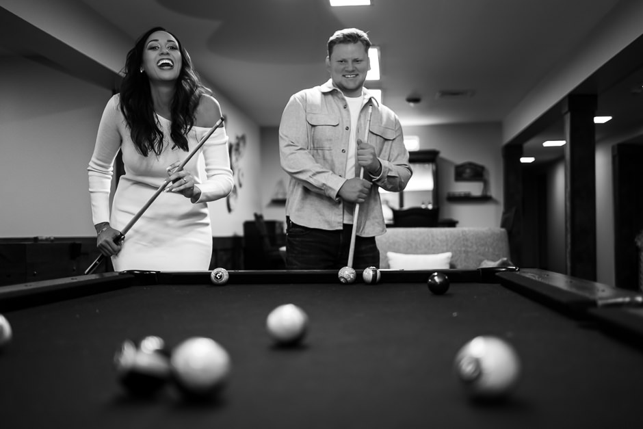 Engaged couple playing pool together in Speakeasy at Warren Place Venue 
