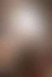 engaged couple sitting on couch at Warren Place Venue snuggling