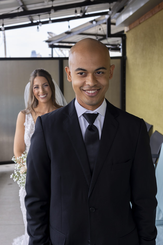 Bride and groom smiling before groom's first look before wedding