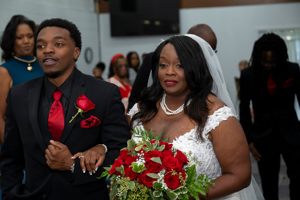 bride looking at her groom as she walks down the isle
