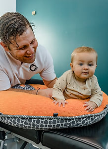 Dr. Tanner Wedding adjusting an infant in Core Chiropractic
