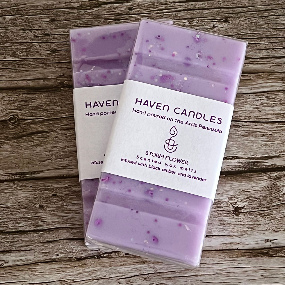 Two Haven Candles Storm Flower wax melt bars on wooden surface. Purple with glitter.