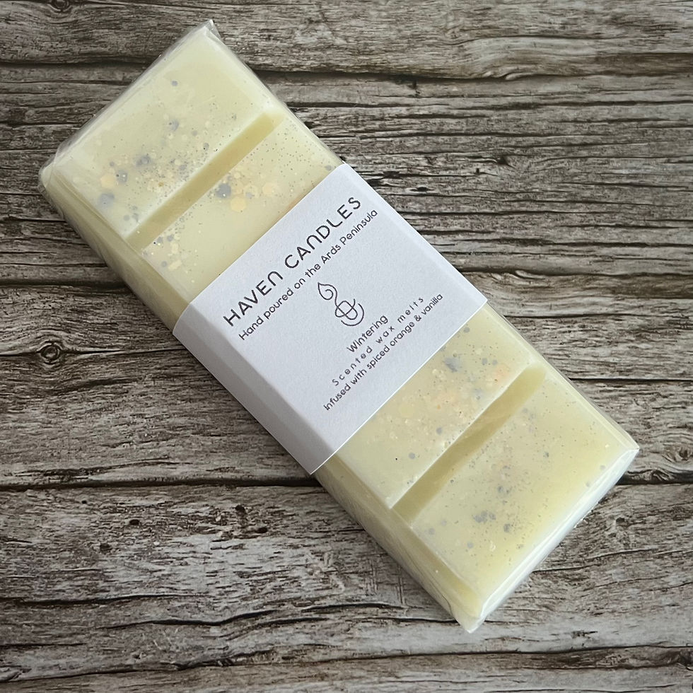 Haven Candles Wintering wax melt bar. Infused with spiced orange and vanilla on wooden table.