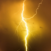 A golden lightening bolt striking against a dark sky.
