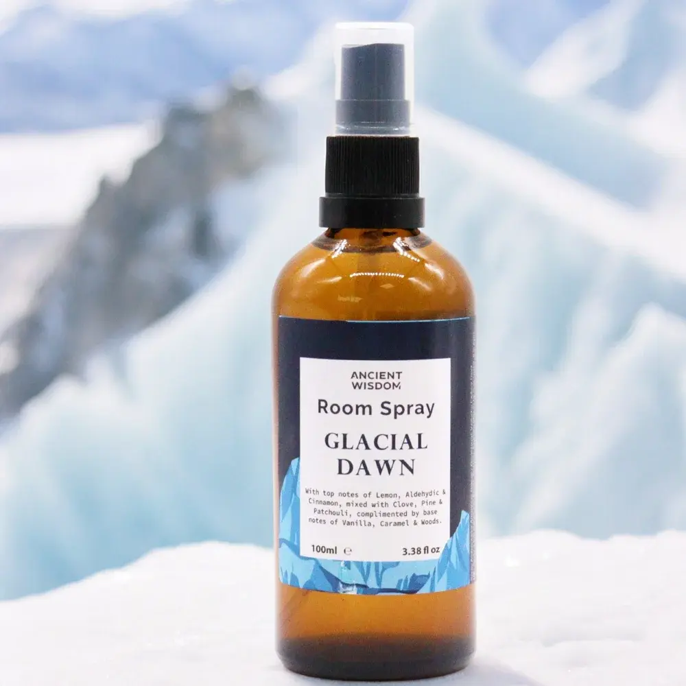 Room Spray Glacial Dawn bottle against icy background scene backdrop.