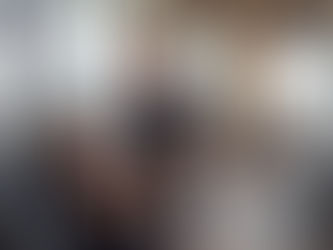 Personal training session at Barry McGinley Coaching in Dubai gym, trainer guiding client on chest press machine with city skyline view.