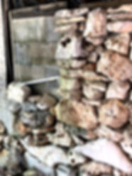Rock wall built by dementia. The left side is haphazard with goopy mortar but the right is beautiful with honeycomb rocks stacked in aesthetic order with rocks hand picked from Hudson Bend near Lake Travis (Austin, TX).