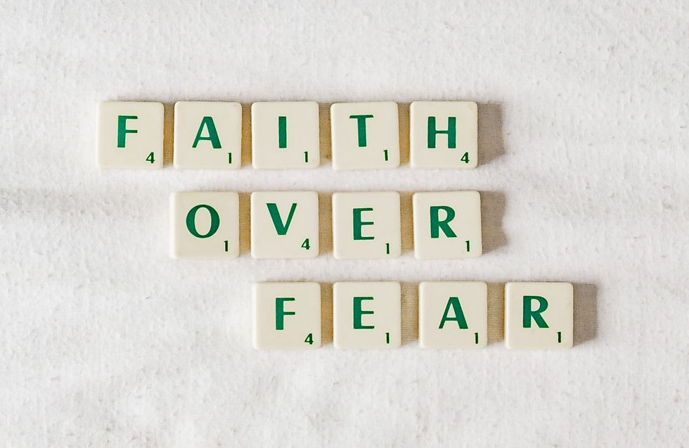 Scrabble tiles spell out "Faith over Fear".