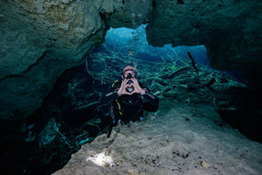 scuba diver giving heart hand signal under water in a cavern dive
