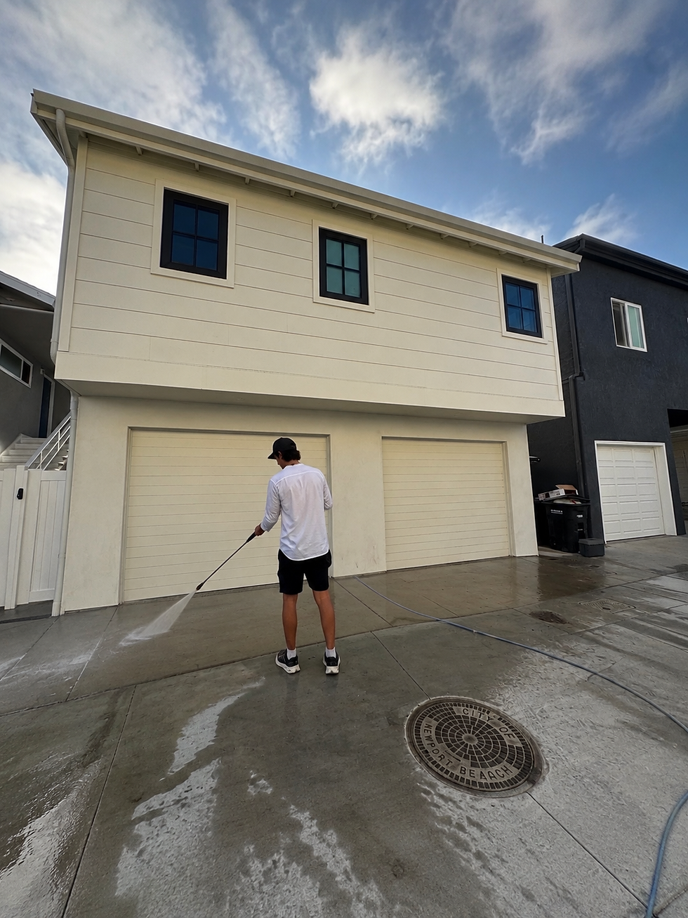 Worker providing residential exterior pressure washing service