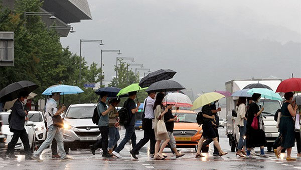 Pedestrians in Seoul under umbrellas during a typhoon warning. Pulse (Maeil Business News Korea) - pedestrians amid typhoon alerts
