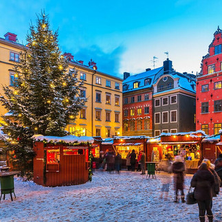 Christmas market in Gamla Stan, Stockholm, Sweden, with wooden stalls, a decorated tree, and snow-covered streets capturing Europe’s traditional holiday atmosphere