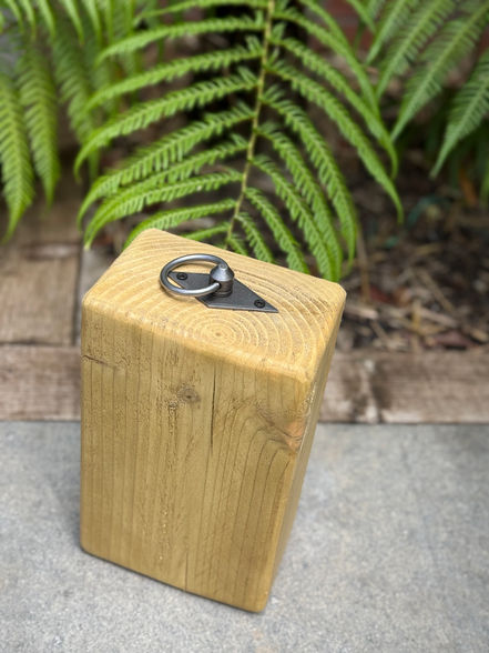 A rustic iron ring handle door stopper