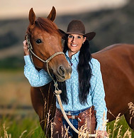 Sandy walking horse in field – grounding wellness in nature, movement, and connection
