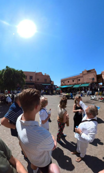 Group of tourists visiting the Jema El fna place in a sunny afternoon