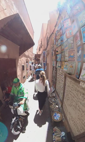 Woman with long hair walking in a narrow street of the Marrakech medina