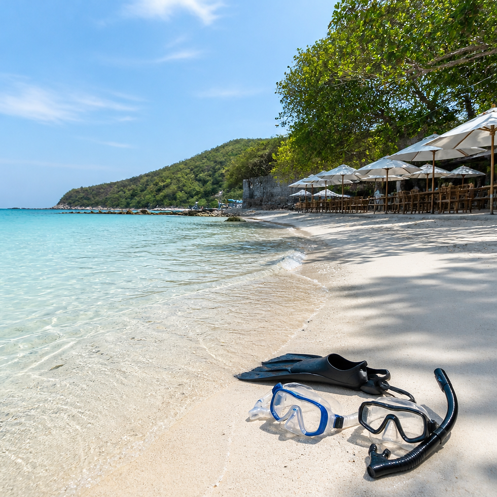 Snorkel gear on white sand beside shallow turquoise water at a quiet beach on Koh Larn