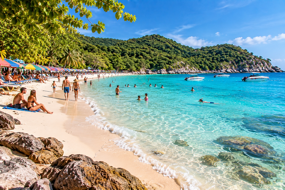 Travelers swimming and relaxing at one of the best beaches on Koh Larn with clear turquoise water and pale sand